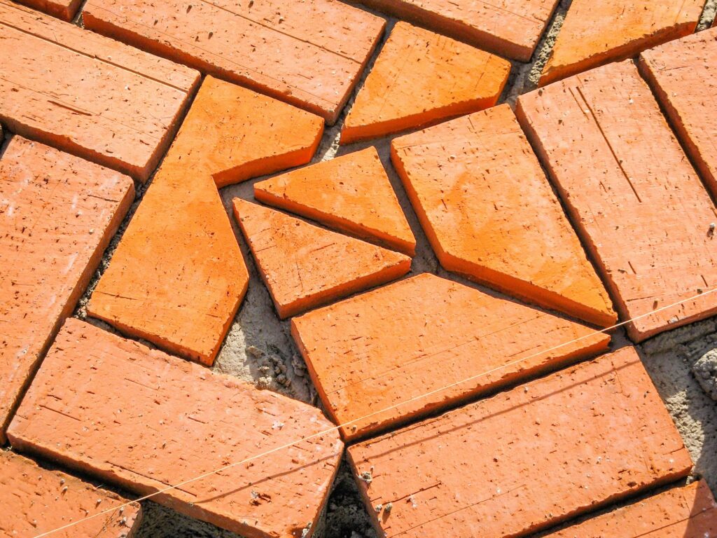 Orange brick paving stones in construction process